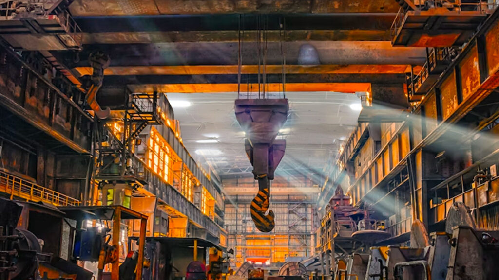 the inside of a steel manufacturing plant with active temporary ceiling protection during a reroofing project